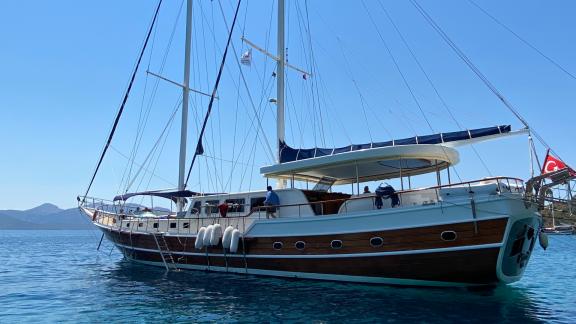 The Gulet Sahinoğlu, an elegant sailing ship with 7 cabins, lies majestically in the clear blue water, ready for luxurio